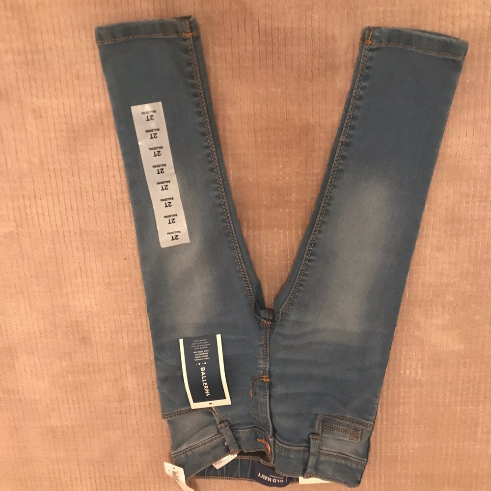 2T girls jeans, med. wash denim with fade marks